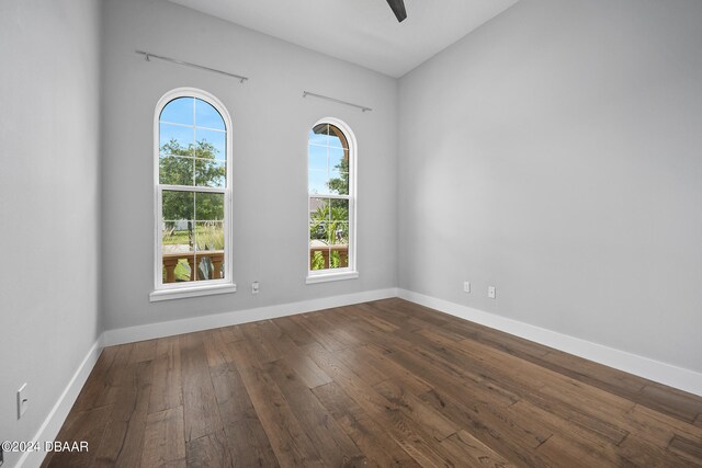 spare room with hardwood / wood-style floors, a healthy amount of sunlight, and ceiling fan