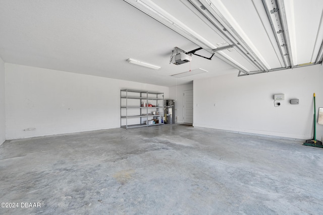 garage with a garage door opener and heat pump water heater