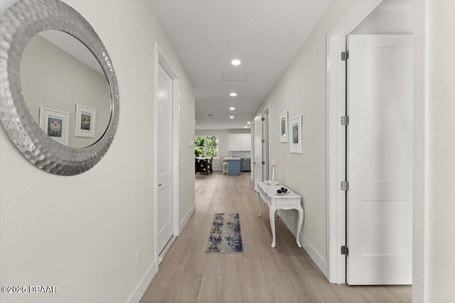 corridor with light wood-type flooring