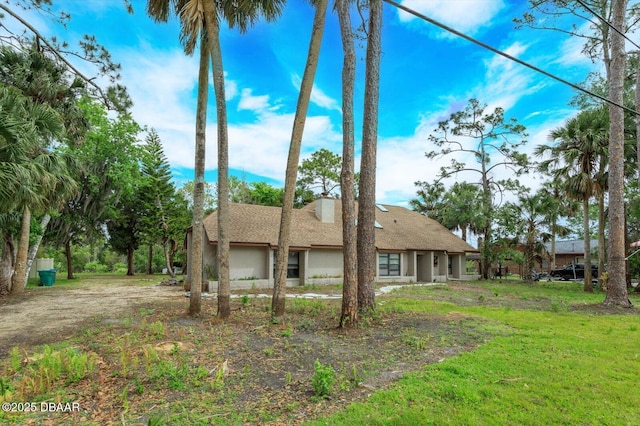 rear view of property with a yard