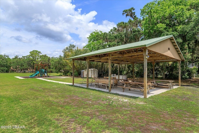 view of property's community with a patio area, a lawn, a storage shed, and a playground