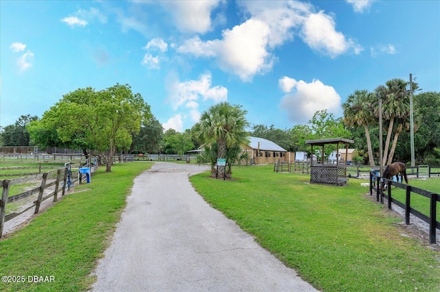 view of property's community with a yard and a rural view