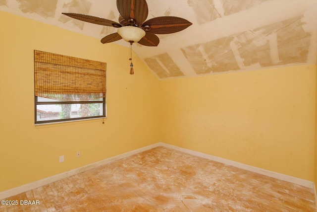 spare room featuring ceiling fan and vaulted ceiling