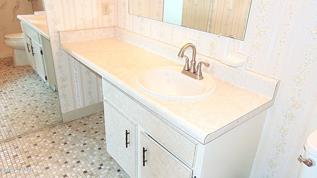 100 Silver Beach Ave Unit 710, Daytona Beach, FL 32118 - bathroom with toilet, vanity, wallpapered walls, and tile patterned floors