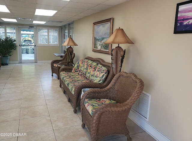 100 Silver Beach Ave Unit 710, Daytona Beach, FL 32118 - living area featuring light tile patterned flooring, baseboards, and a drop ceiling