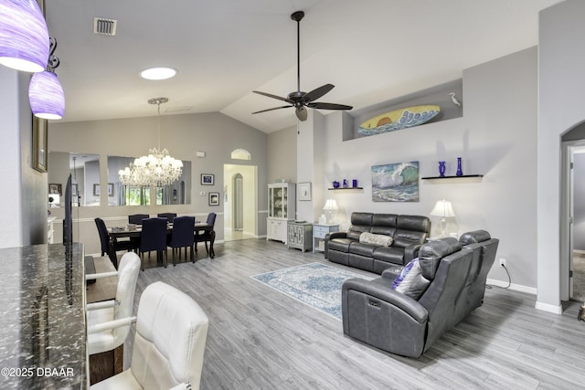 30 Foxfield Look, Ormond Beach, FL 32174 - living room with visible vents, arched walkways, wood finished floors, baseboards, and ceiling fan with notable chandelier