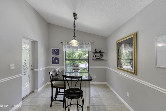 30 Foxfield Look, Ormond Beach, FL 32174 - dining space featuring a textured ceiling, light tile patterned floors, and lofted ceiling