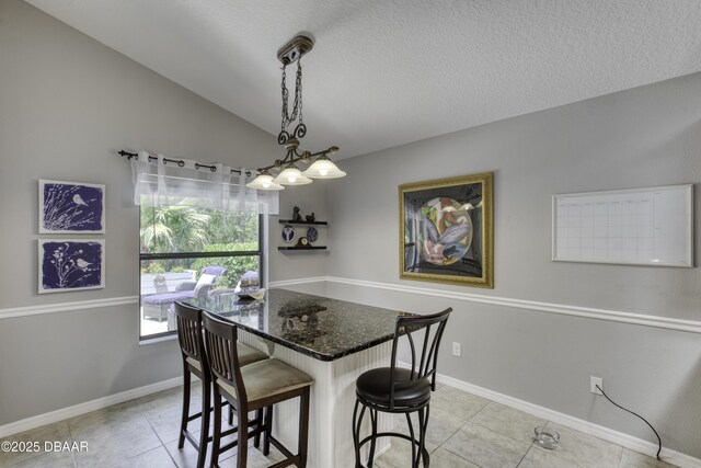 30 Foxfield Look, Ormond Beach, FL 32174 - dining room featuring baseboards, a textured ceiling, lofted ceiling, and light tile patterned flooring