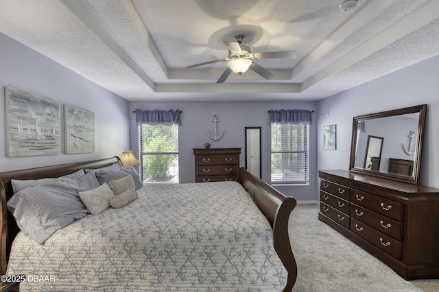 30 Foxfield Look, Ormond Beach, FL 32174 - bedroom featuring ceiling fan, light carpet, a raised ceiling, a textured ceiling, and baseboards