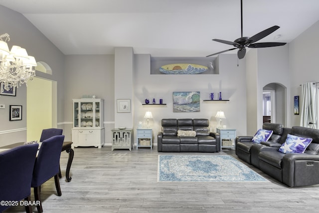 30 Foxfield Look, Ormond Beach, FL 32174 - living area with arched walkways, ceiling fan with notable chandelier, light wood finished floors, and high vaulted ceiling