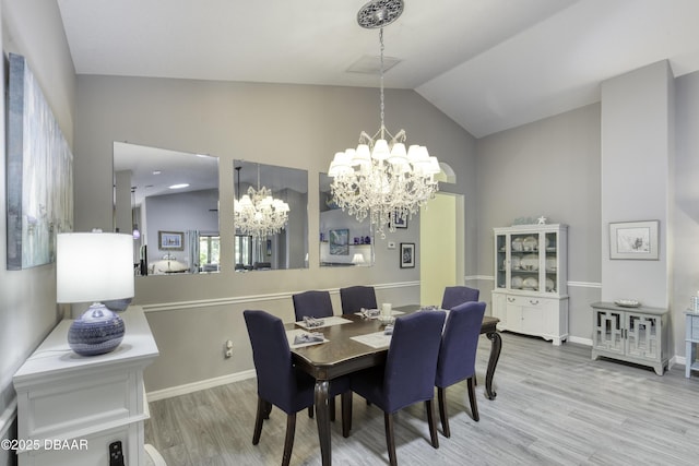 30 Foxfield Look, Ormond Beach, FL 32174 - dining area with baseboards, lofted ceiling, wood finished floors, and a notable chandelier