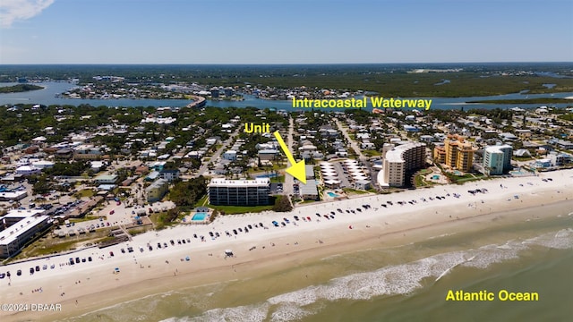 bird's eye view featuring a water view and a beach view