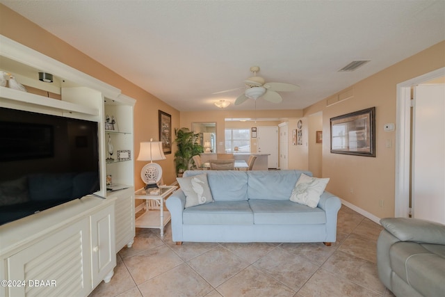 tiled living room with ceiling fan