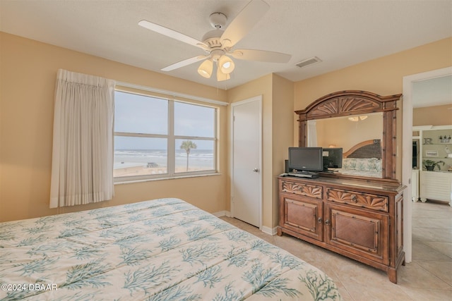 bedroom with ceiling fan and light tile patterned flooring