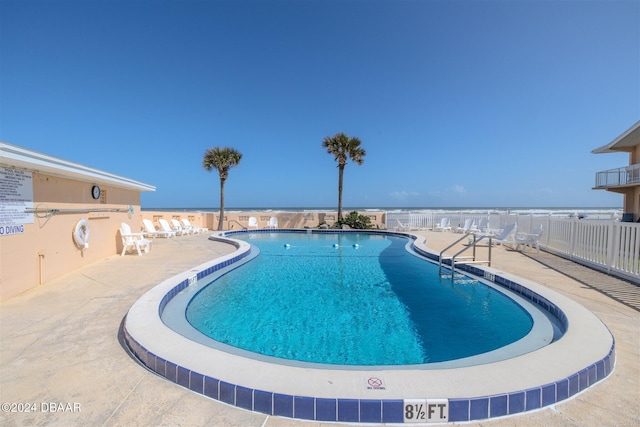 view of swimming pool with a patio area