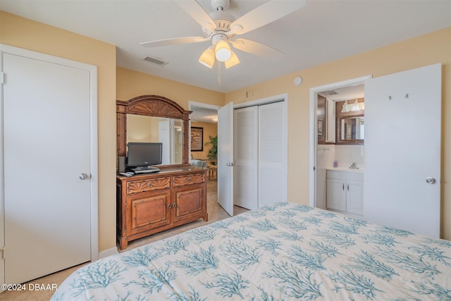 bedroom featuring ensuite bathroom, a closet, ceiling fan, and light tile patterned floors