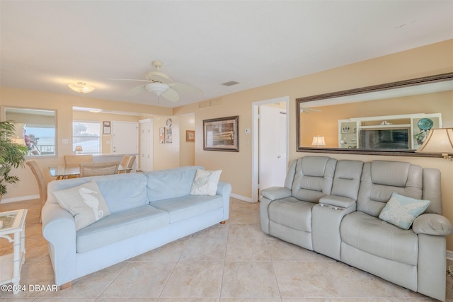 tiled living room with ceiling fan