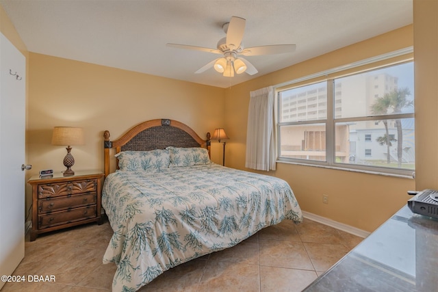 bedroom featuring ceiling fan and light tile patterned floors