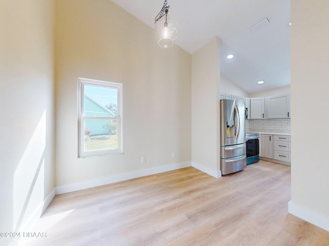 unfurnished living room with light hardwood / wood-style floors and lofted ceiling