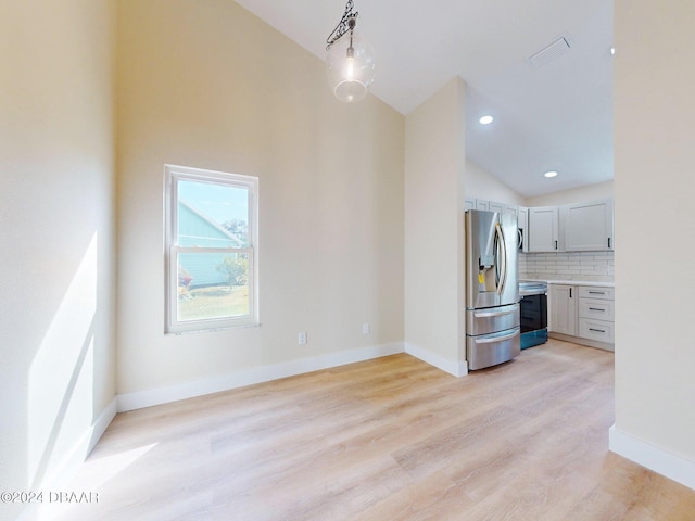 804 Soft Pine Ct, New Smyrna Beach, FL 32168 - unfurnished living room with light wood-style floors, baseboards, high vaulted ceiling, and recessed lighting
