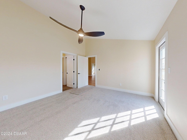 carpeted spare room with high vaulted ceiling and ceiling fan