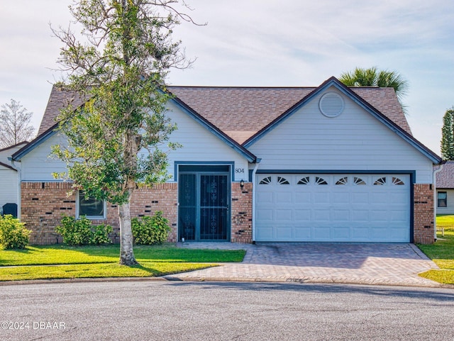 804 Soft Pine Ct, New Smyrna Beach, FL 32168 - ranch-style home with brick siding, an attached garage, driveway, and roof with shingles