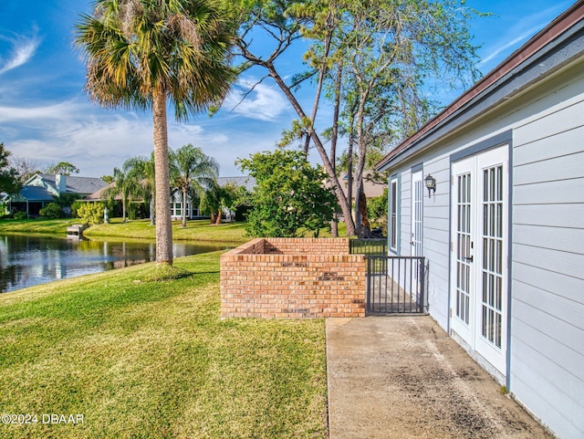 exterior space featuring french doors and a water view