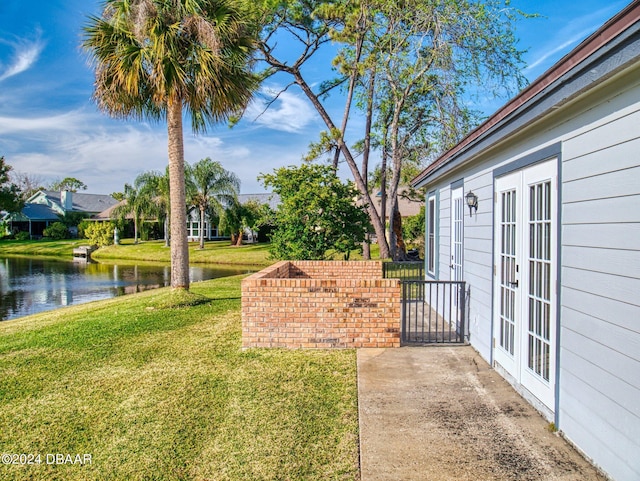 804 Soft Pine Ct, New Smyrna Beach, FL 32168 - view of grassy yard with french doors and a water view