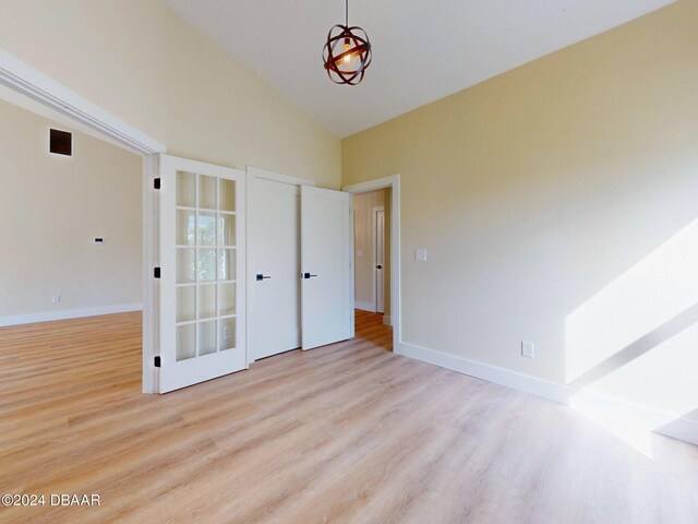 804 Soft Pine Ct, New Smyrna Beach, FL 32168 - empty room featuring wood finished floors, high vaulted ceiling, and baseboards