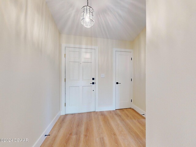 804 Soft Pine Ct, New Smyrna Beach, FL 32168 - foyer with light wood-type flooring, baseboards, and a chandelier