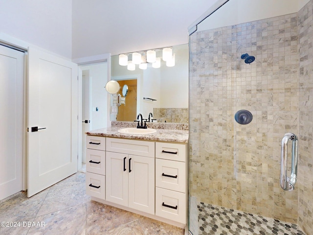 bathroom featuring vanity, tile patterned floors, and a shower with door