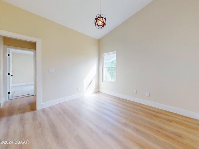 unfurnished room with high vaulted ceiling and light hardwood / wood-style floors