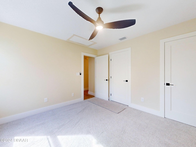 unfurnished bedroom featuring carpet and ceiling fan