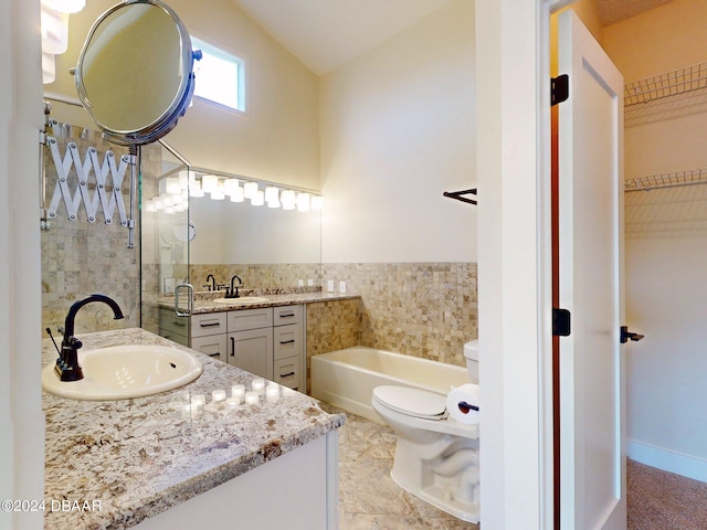 bathroom featuring a tub, vanity, and toilet