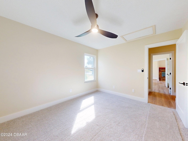 unfurnished bedroom featuring ceiling fan and light carpet