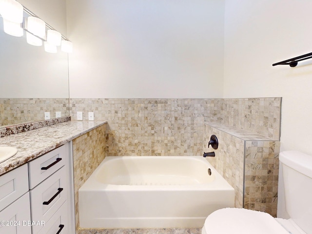 bathroom featuring vanity, toilet, a tub, and tile walls