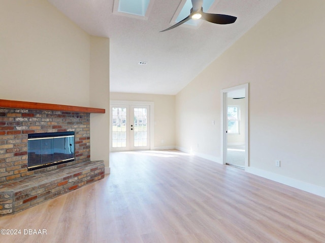 804 Soft Pine Ct, New Smyrna Beach, FL 32168 - unfurnished living room featuring wood finished floors, a ceiling fan, a fireplace, high vaulted ceiling, and baseboards