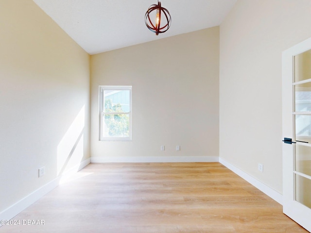 804 Soft Pine Ct, New Smyrna Beach, FL 32168 - spare room featuring light wood-style floors, lofted ceiling, and baseboards