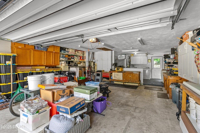 garage featuring a garage door opener, a workshop area, and independent washer and dryer