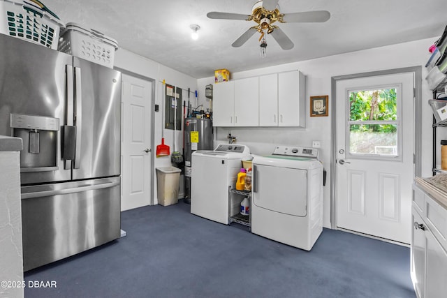 clothes washing area featuring cabinet space, water heater, a ceiling fan, and washer and dryer