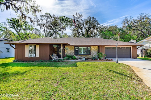 single story home with a front lawn, a garage, and driveway