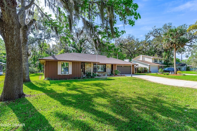 ranch-style house with board and batten siding, a front yard, driveway, and an attached garage