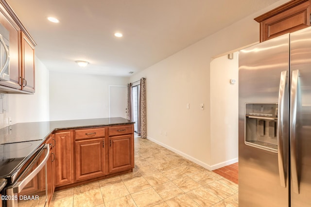 2017 Cornell Pl, Port Orange, FL 32128 - kitchen with appliances with stainless steel finishes, a peninsula, recessed lighting, and brown cabinetry
