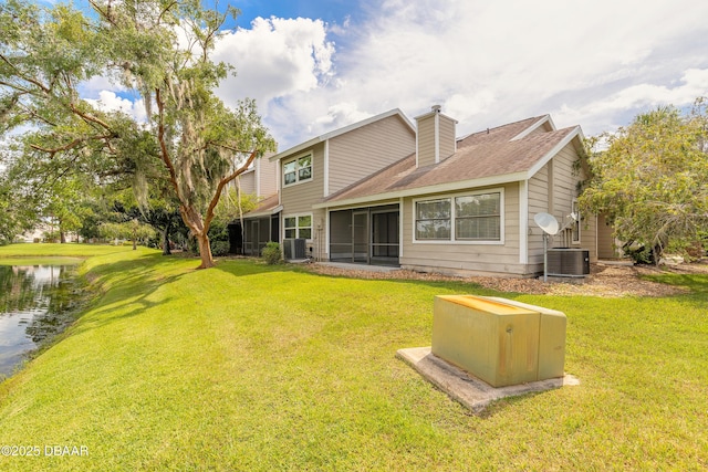 2017 Cornell Pl, Port Orange, FL 32128 - back of property featuring a chimney, a sunroom, a yard, and roof with shingles