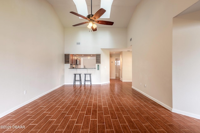 2017 Cornell Pl, Port Orange, FL 32128 - unfurnished living room featuring high vaulted ceiling, a ceiling fan, and dark wood-style flooring