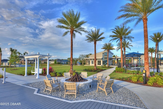 surrounding community featuring a yard, an outdoor fire pit, fence, and a pergola