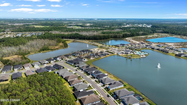 birds eye view of property featuring a water view, a forest view, and a residential view