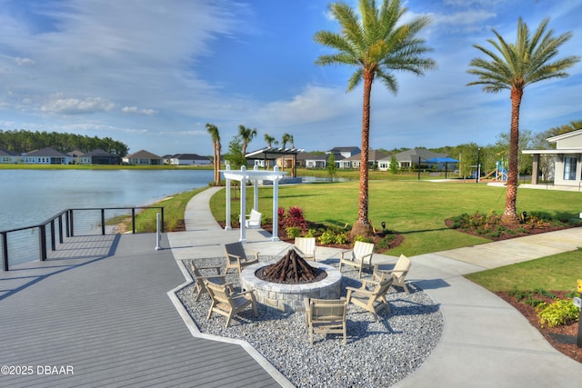 view of home's community with a residential view, a water view, a yard, and a pergola