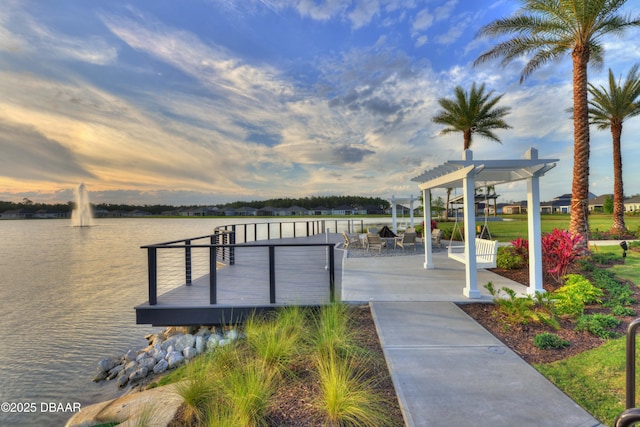 view of dock with a water view and a pergola