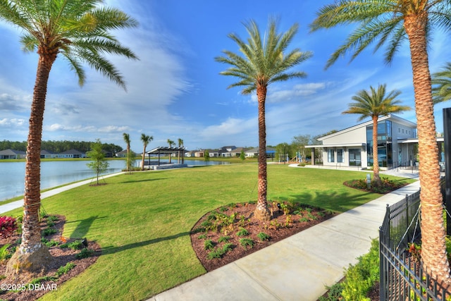 view of community featuring a lawn and a water view